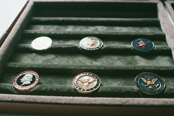 A velvet-lined box displaying six collectible coins neatly arranged.