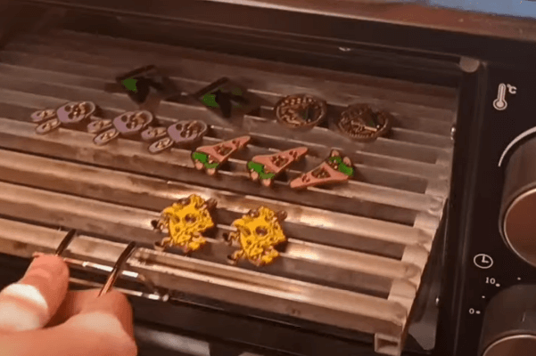 Baking enamel badges in an oven