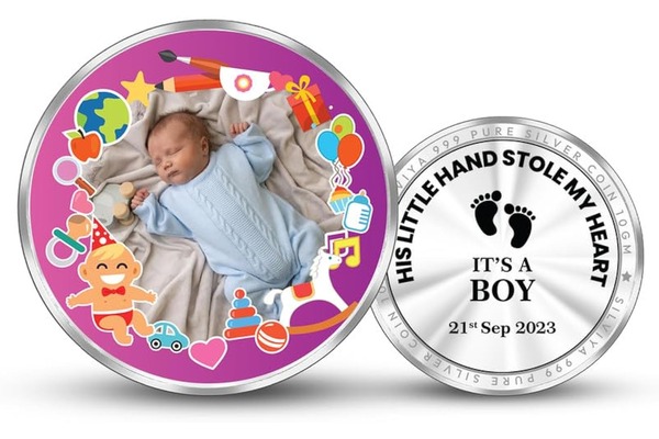 Silver coin with baby boy design, birth announcement.