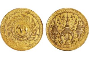 Ancient Thai gold coin with elephant and temple designs