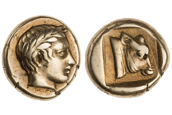 Ancient Greek silver coin with a laurel-crowned profile