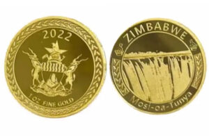 Золотая монета Зимбабве с участием водопада Виктория и национальной эмблемы.